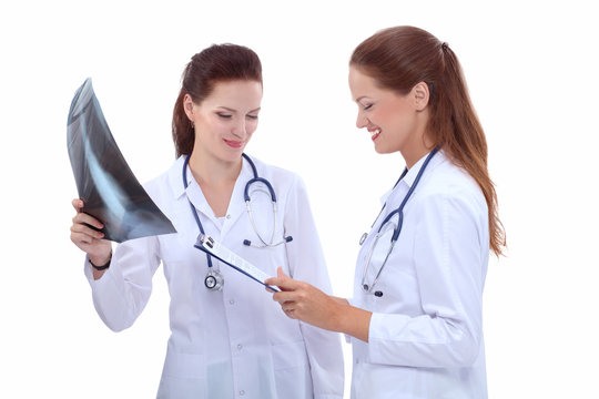 Two woman  nurse watching X Ray image, standing in hospital