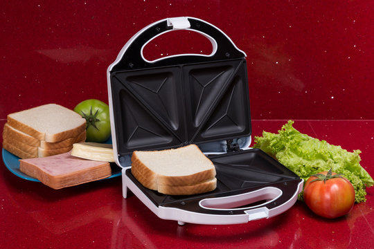 Sandwich Toaster with ingredients in a kitchen setting