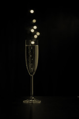 Glass of champagne with colored bubbles