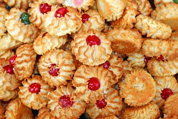 many pastries and almond biscuits with icing and candied fruit