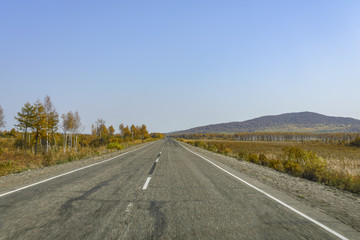 Fototapeta na wymiar Mountain road on the Far Eastern taiga. Mountain road on a ridge of the Sikhote - Alin , Far East Russia .