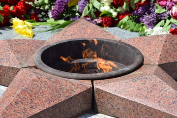 The laid flowers to an eternal flame in honor of a Victory Day on May 9