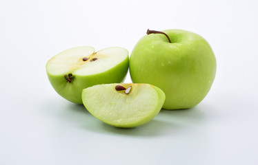 Ripe green apple and slice on white background