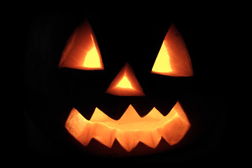 Halloween pumpkin with scary face in dark
