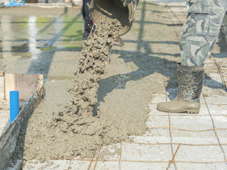 Worker pouring cement in construction site
