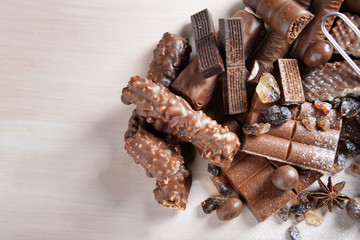 Chocolate sweets with powder on wooden background