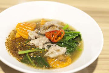 Fried noodle with pork and kale soaked in gravy soup