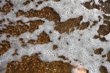 Macro photo of the sea foam in the tide