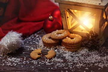 Christmas cookies and a burning lantern for the Christmas Eve