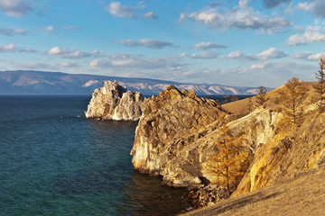 Fototapeta na wymiar Lake Baikal autumn evening. Beautiful rocky coast of Olkhon Island at sunset light