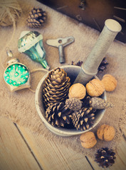 Fototapeta na wymiar toys for the Christmas tree and pine cones on old wooden background