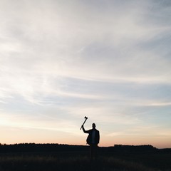 lonely man hipster silhouette with ax