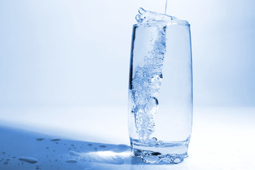 water pouring in transparent glass with bubbles of air