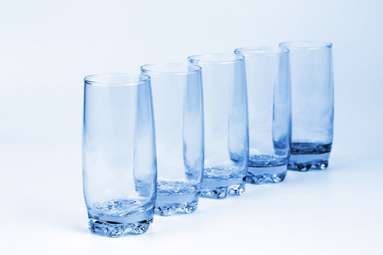 five blue transparent glass with a light blue background