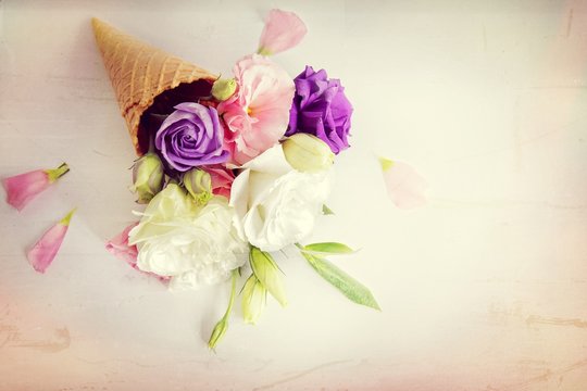 Fresh flowers in ice cream cone in vintage style