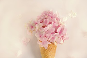 Fresh flowers in ice cream cone in vintage style
