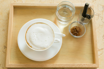 Hot art Latte Coffee in a cup on wooden table and Coffee shop bl