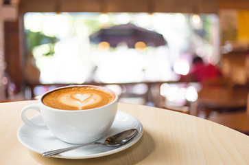 Selected focus empty brown wooden table and Coffee shop blur bac