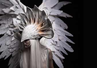 Angel, costume, concept, cinematic, a portrait of a young girl and a white wig , which carries a large white mask and a large white wings. Dramatic