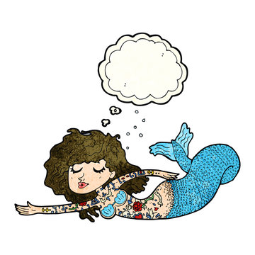 cartoon mermaid covered in tattoos with thought bubble