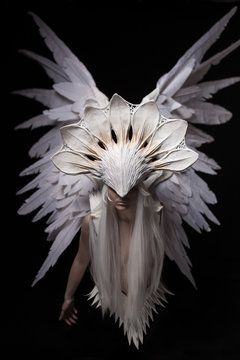 a portrait of a young girl and a white angel costume