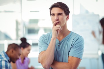 Young creative worker thinking