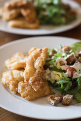 Fried fish with Caesar salad.