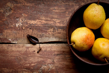 Fresh pears in a bowl on the wooden table - Powered by Adobe