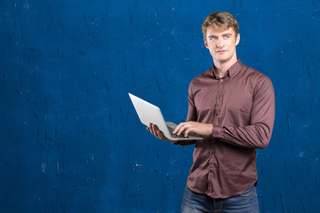 Young man holding laptop