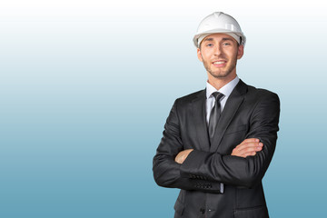 Young handsome engineer in white hardhat