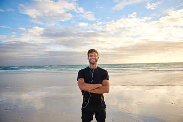 Man smiling on the beach in the morning before his run