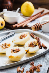 add honey to a pear with walnuts, cinnamon sticks, cooking proce