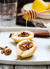 spicy baked pear with walnuts, honey, cinnamon sticks, healthy d