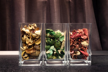 Fragrant dried flower petals in glass