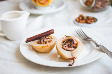 spicy baked pear with walnuts, honey, cinnamon sticks, healthy d