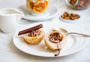 spicy baked pear with walnuts, honey, cinnamon sticks, healthy d