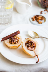spicy baked pear with walnuts, honey, cinnamon sticks, healthy d