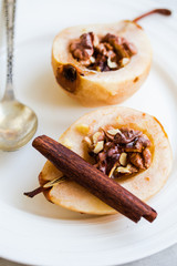 spicy baked pear with walnuts, honey, cinnamon sticks, healthy d