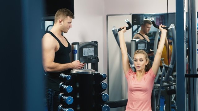 Attractive woman trained in the gym with a personal trainer