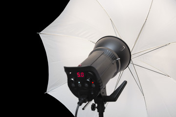 photography studio strobe flash with white umbrella and black co