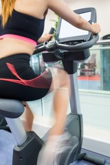 Fototapeta na wymiar Woman exercising on an exercise bike