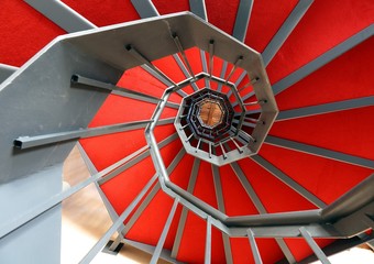 spiral staircase with red carpet in a modern building