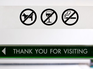 Set of prohibit sign at cafeteria's door include no dogs no alcohol and no smoking.