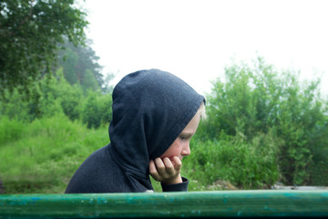 Upset teenager sitting alone