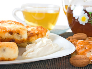 image of a cup of tea, cheesecakes and cookies closeup