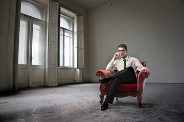 Man sitting in a red armchair