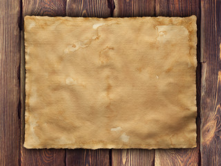 Old paper sheet on wooden wall background