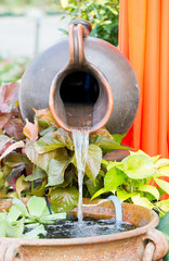 Close up of clay water feature with pond.