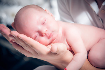 Newborn baby sleeping on the shoulder of his father