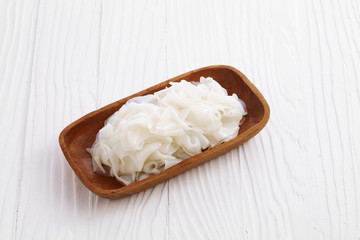 chinese dry noodle in wooden dish on white background